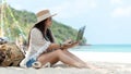 Lifestyle freelance woman using laptop working and relax on the beach
